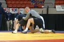 Cael Sanderson warming up